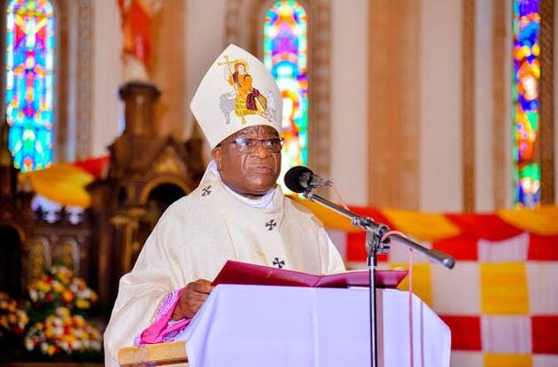 Archbishop Paul Ssemwogerere, the current leader of St. Mary's Cathedral Rubaga, speaking at a public event in Kampala.
