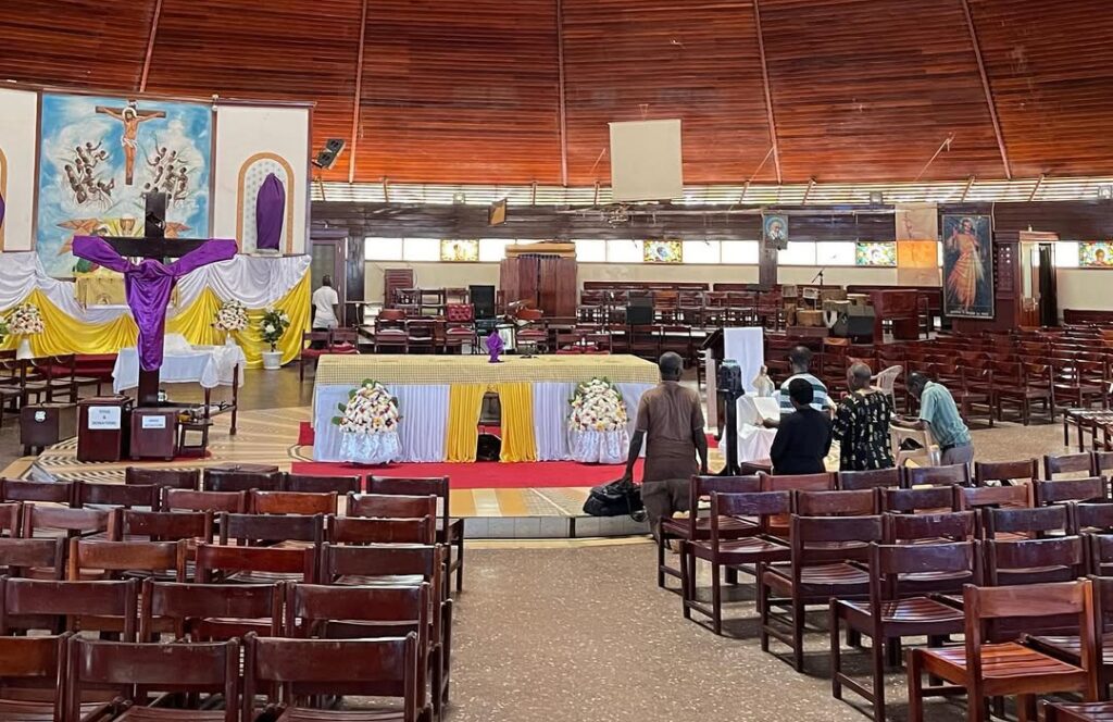 Inside the Uganda Martyrs’ Shrine, with wooden pews arranged in a circular pattern, offering a peaceful space for prayer and reflection