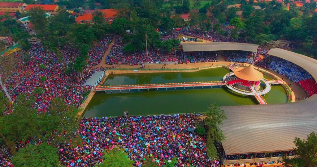 Aerial view of thousands of pilgrims gathered around Martyrs’ Lake at Namugongo on June 3rd, celebrating Martyrs’ Day in a vibrant display of faith and unity.