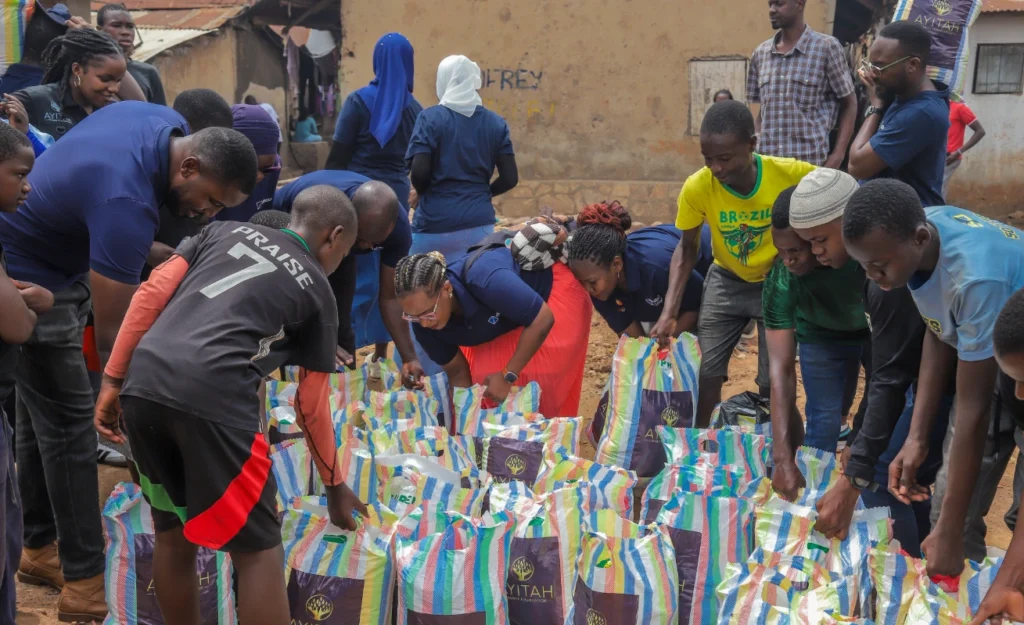Families in Kasokoso slum receiving rice, beans, and cooking oil from Dfcu Bank