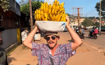 Muzungu Boda carrying a basket of bananas through Kampala streets.