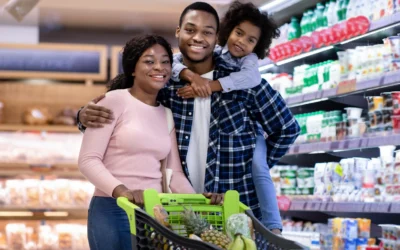 Family shopping for Ramadan essentials in a bustling Ugandan supermarket.