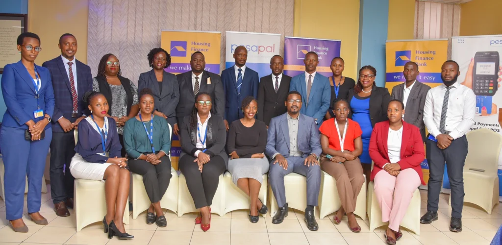 Housing Finance Bank team and Pesapal Uganda team pose for a group photo during the event