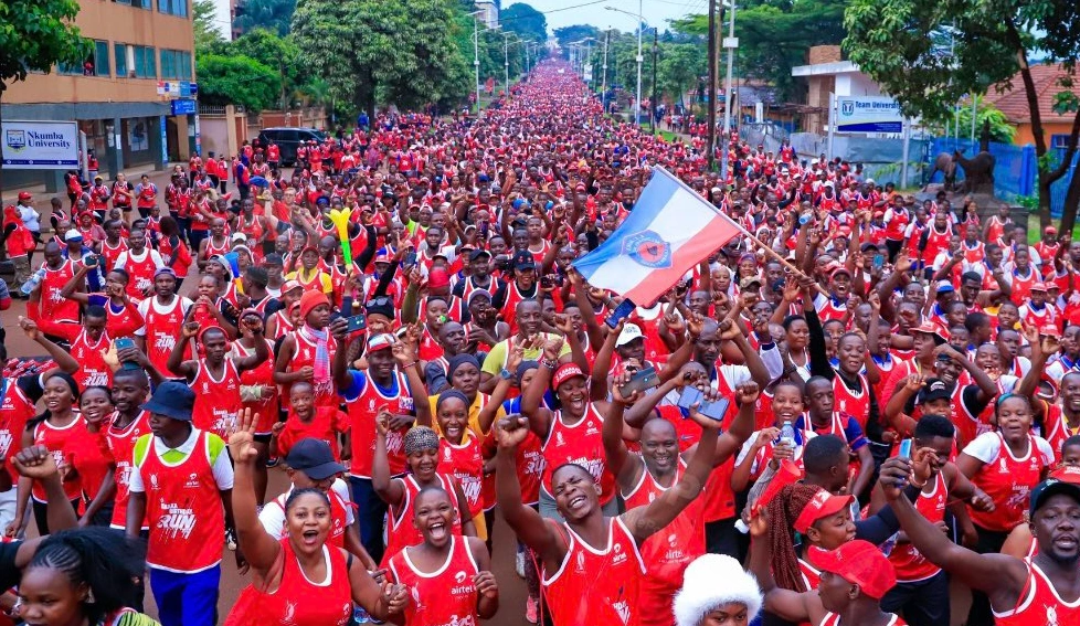 Runners in Airtel red t-shirts participating in the Kabaka Birthday Run under the rain