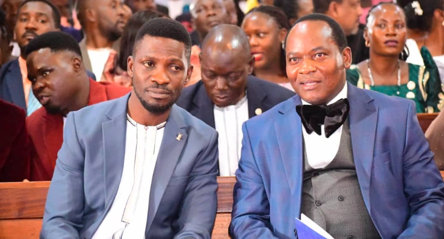 Bobi Wine and Mathias Mpuuga seated together at Rubaga Cathedral during Kabaka’s 70th birthday mass