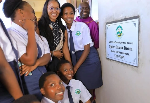 Spice Diana standing in front of the newly named dormitory at St. Andrew’s College Sanda.