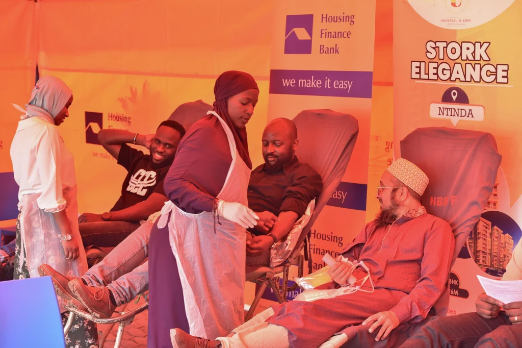 John Baptist Kaweesi-Head Mortgage and Consumer Banking at HFB and Mufaddal Yeolawala - MD Universal M. Enterprises donating blood during the drive